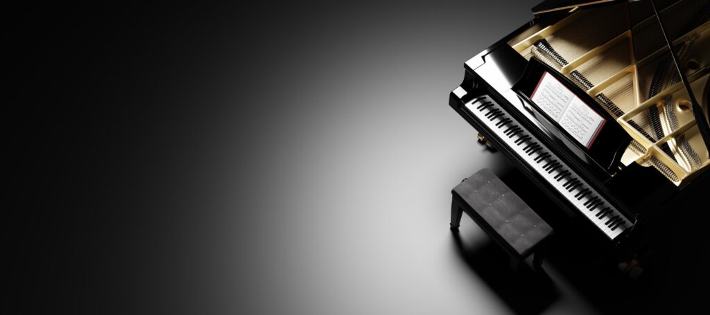 Black grand piano in a dimly lit room, lid open to display interior