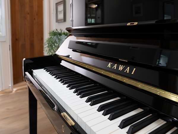 Close-up of Kawai piano keys and brand logo on a new piano